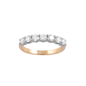 An 18ct yellow gold and platinum round brilliant cut diamond half eternity ring containing seven stones.