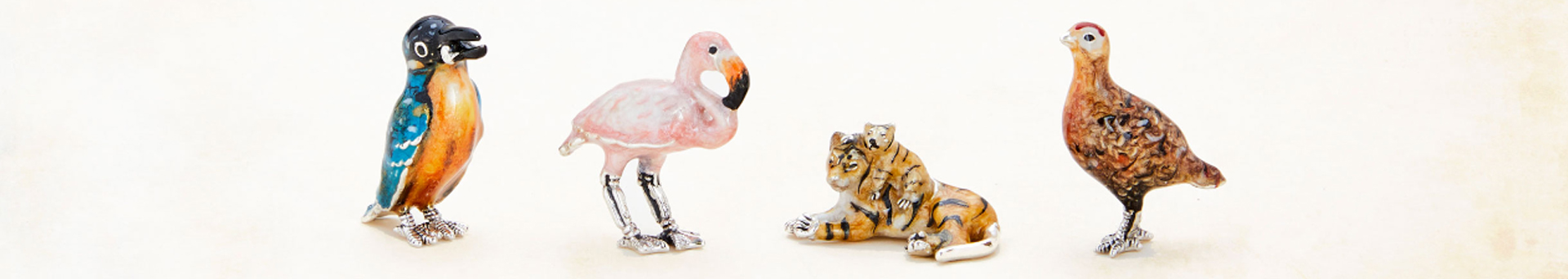 Saturno sterling silver figurines on a pale off-white background.