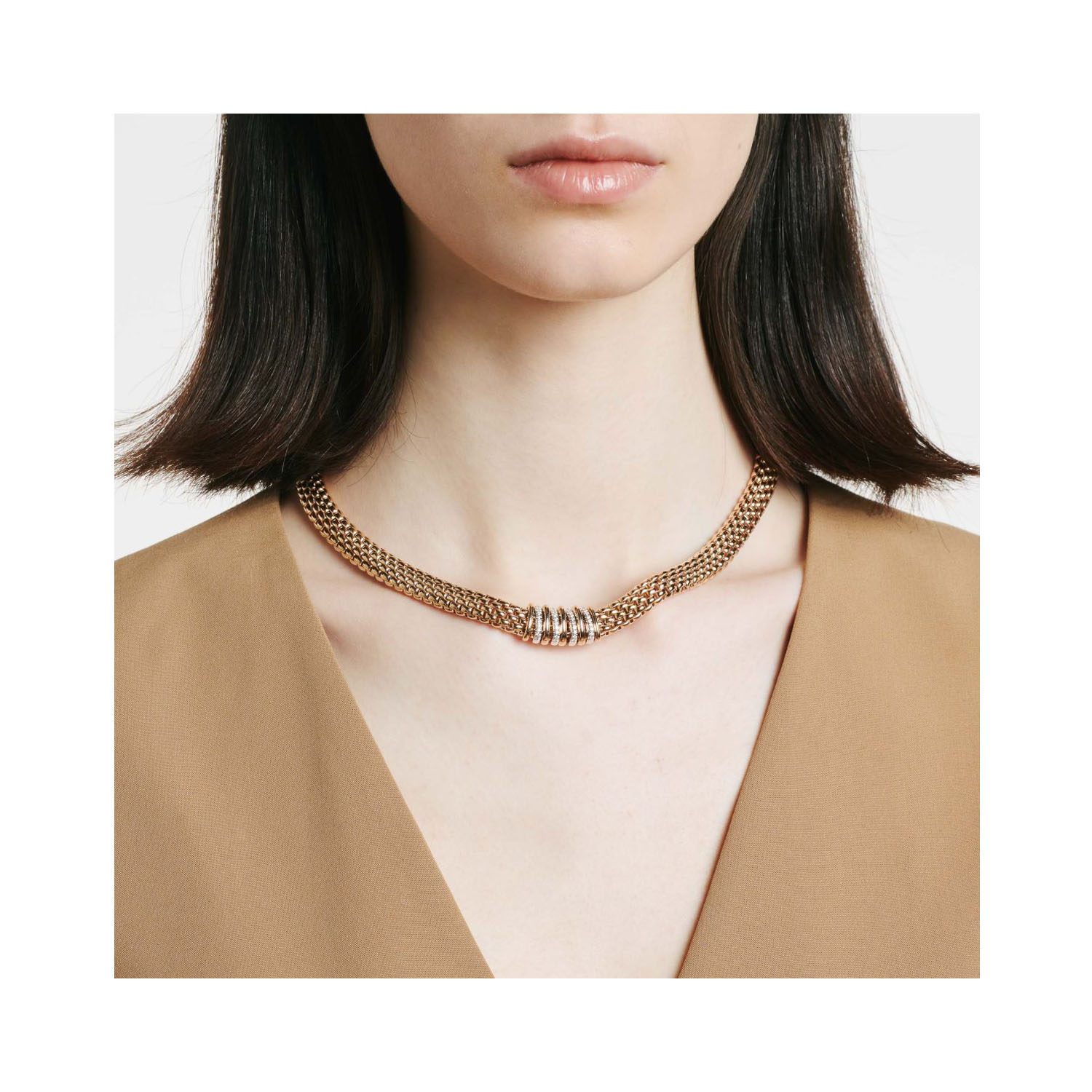 An 18ct yellow gold necklace with four diamond set white gold rondels and five polished rondels belonging to FOPE's Panorama collection.