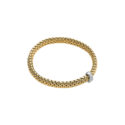 An 18ct yellow gold Flex'It bracelet with a single diamond set white gold rondel belonging to the FOPE Vendôme collection.
