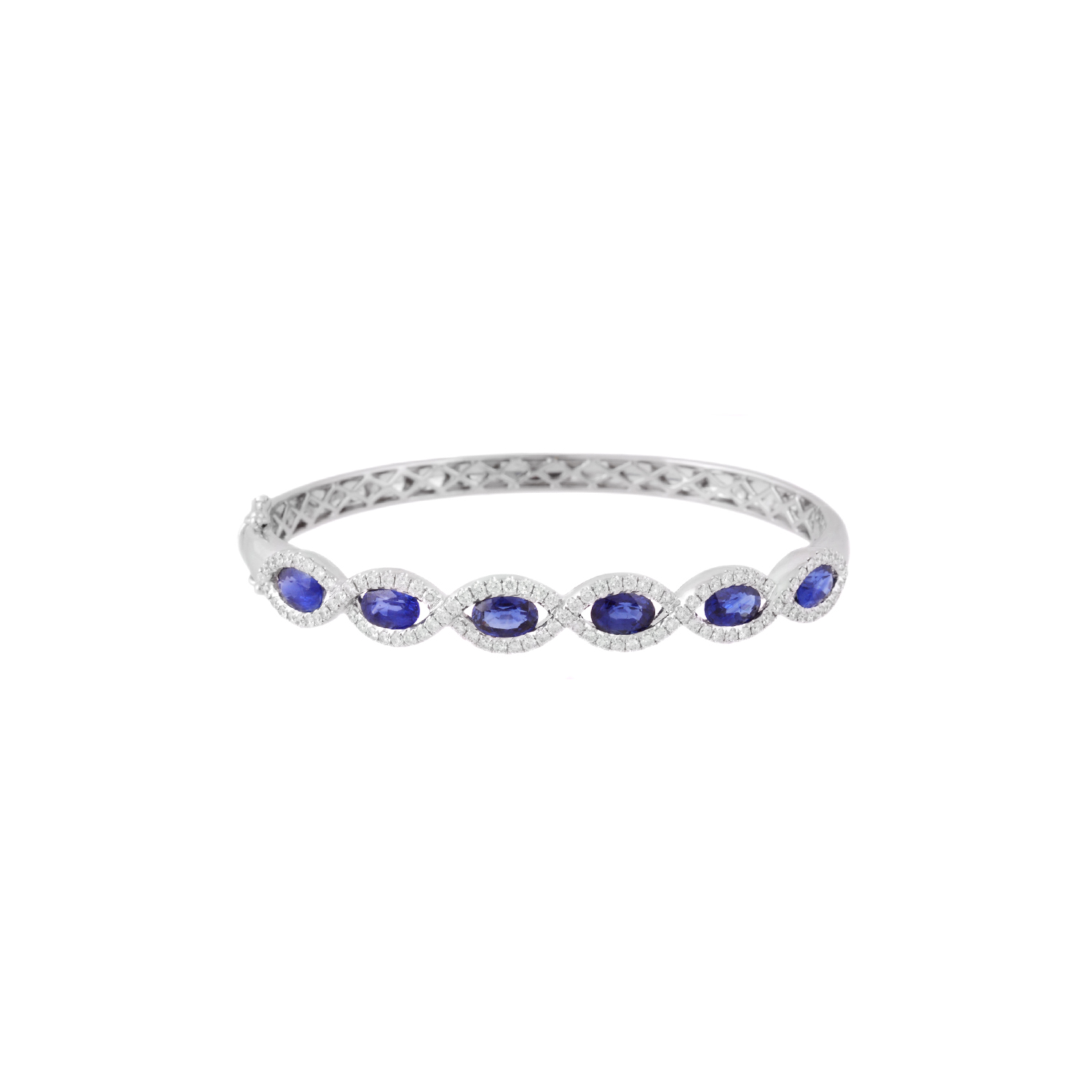 18ct White Gold Sapphire & Diamond Set Fancy Cluster Bangle An 18ct white gold, sapphire and diamond set fancy cluster bangle.