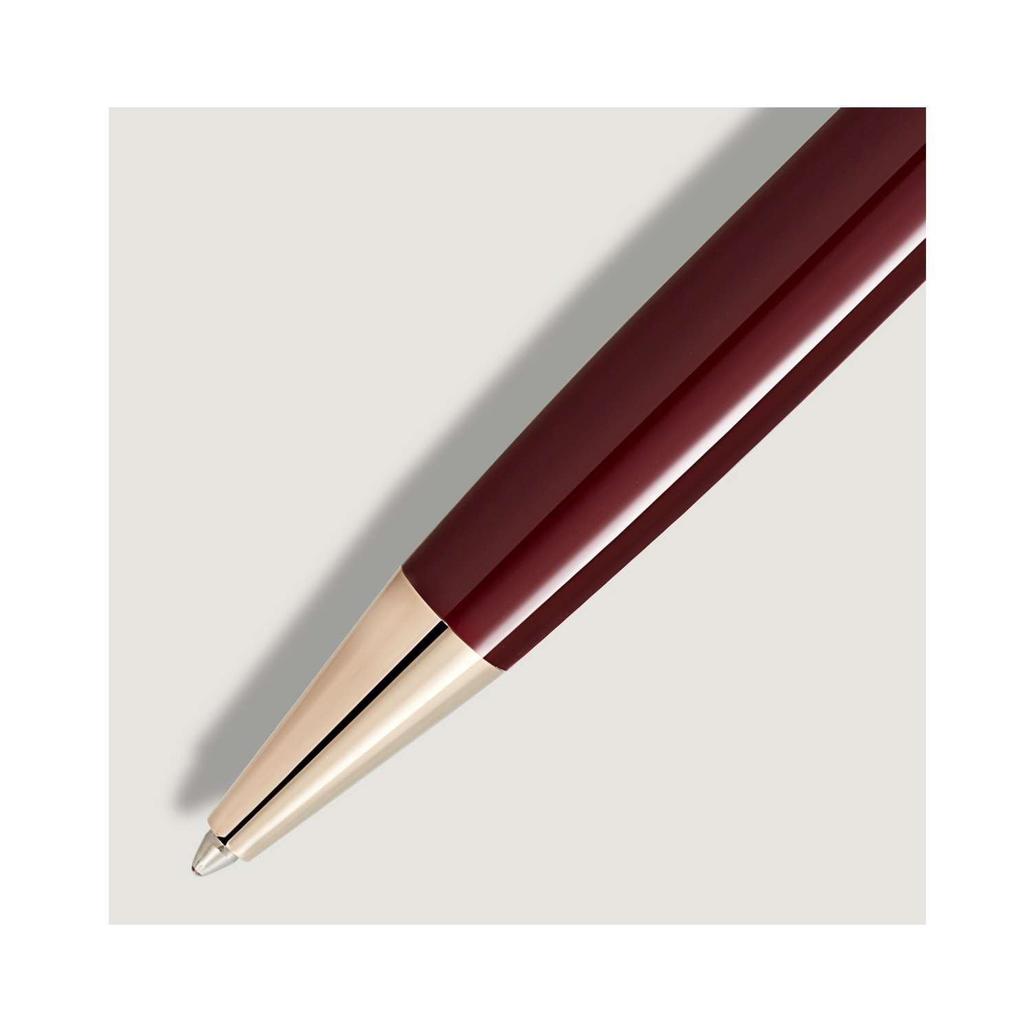 A Montblanc, Meisterstück Burgundy Red Ballpoint pen crafted from red precious resin with gold coated fittings.