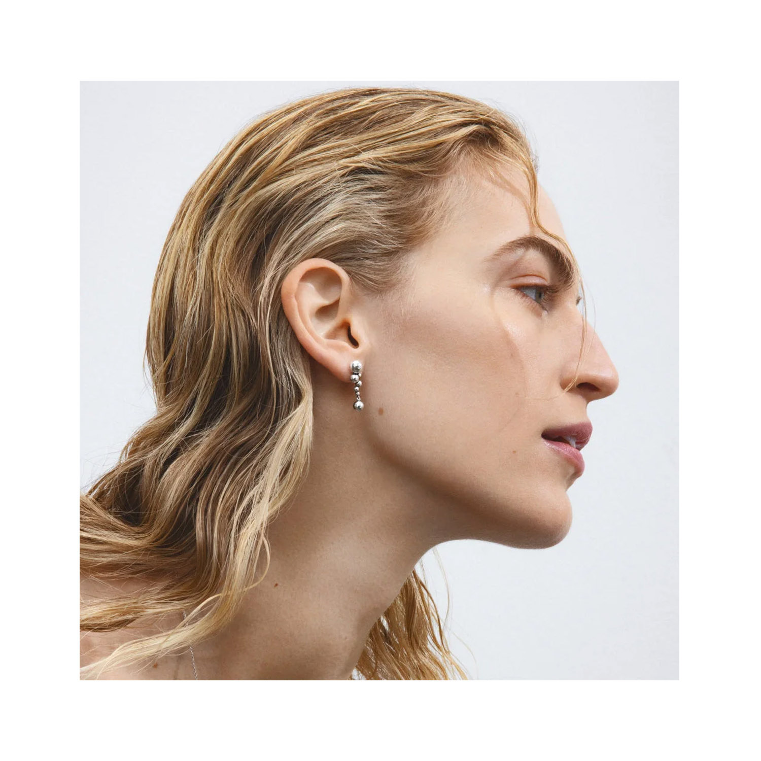 A pair of sterling silver drop earrings for piereced ears, from Georg Jensen's Moonlight Grapes collection.