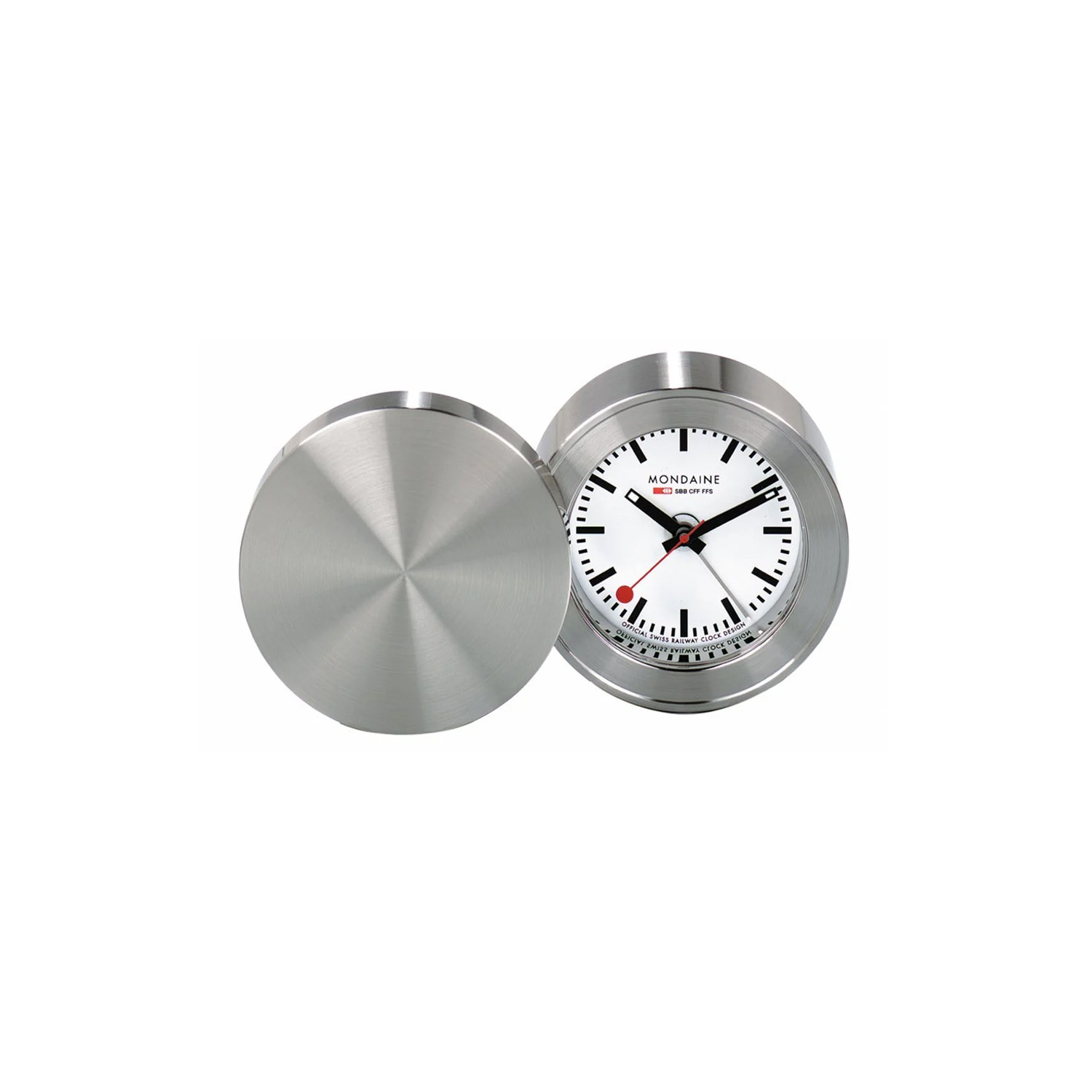 Mondaine, Travel Alarm Clock Mondaine, Travel Alarm Clock with a 50mm brass stainless steel pressed case with an alarm function and a white dial.