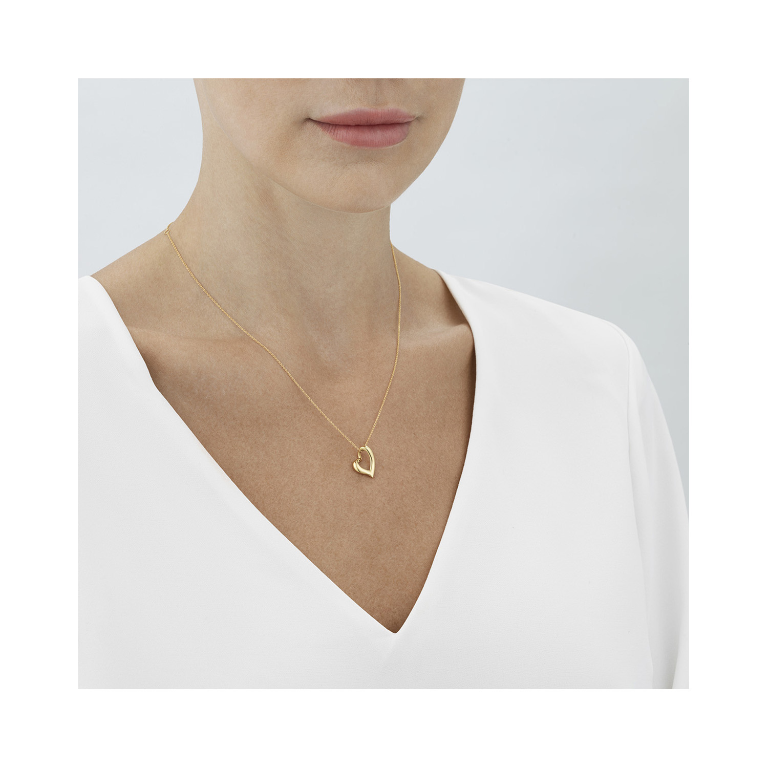 Georg Jensen, 18ct Yellow Gold Hearts of Georg Jensen Pendant & Chain An 18ct yellow gold polished, curved heart pendant and chain from Georg Jensen's Hearts of Georg Jensen collection.