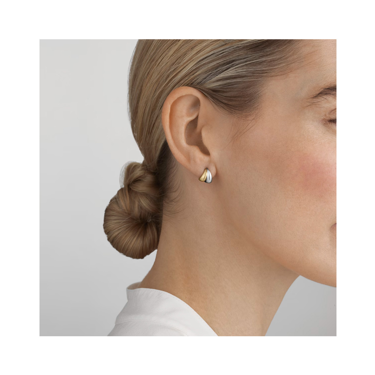 A pair of 18ct yellow gold and sterling silver earrings from Georg Jensen's Curve collection.