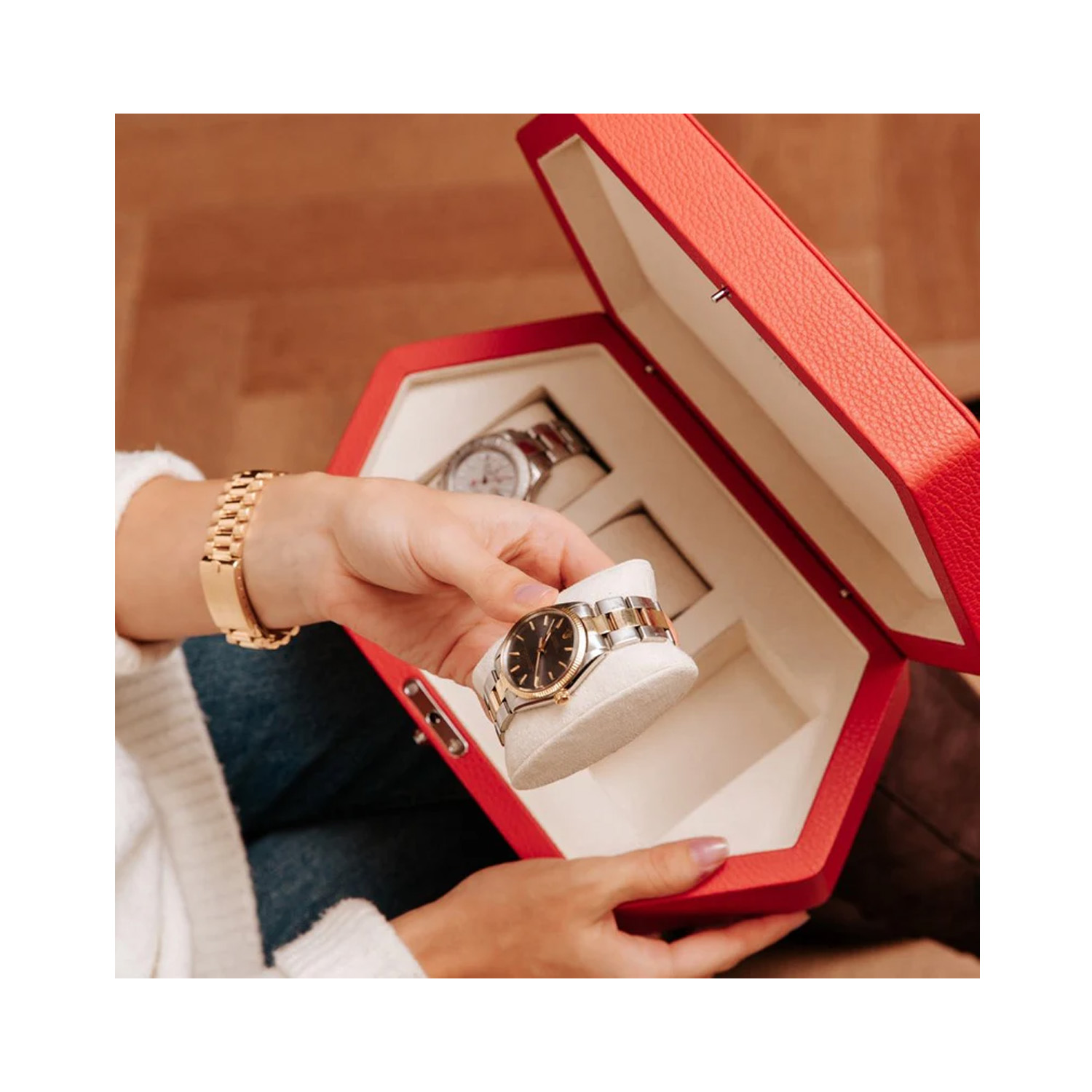 A hexagonal shaped watch box in premium grained red leather that holds up to three watches.