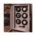 A black lacquered watch winder with space for six watches on patented leather cushions.