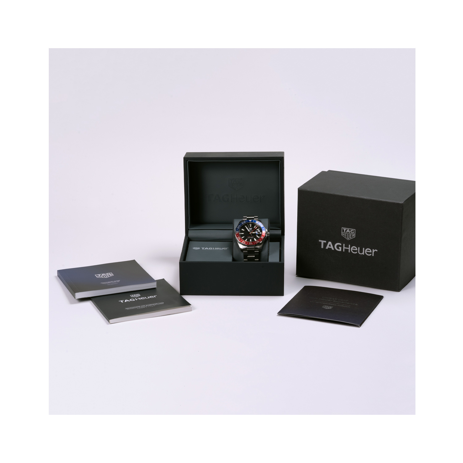 Tag Heuer, Aquaracer GMT, Automatic Men's Watch Tag Heuer, Aquaracer GMT with a 43mm stainless steel case and bracelet strap featuring a date function, GMT and a black dial with a blue and red bezel. Supplied with original box and guarantee dated 2019.