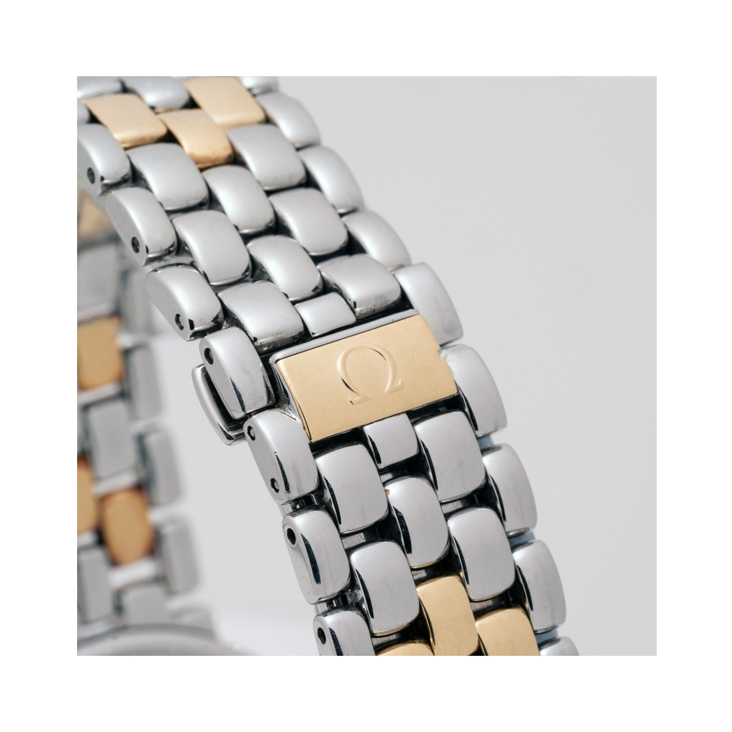 OMEGA, DeVille with a 33mm stainless steel and yellow gold case and bracelet strap featuring a date function and a white, three-handed dial.