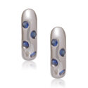 A pair of 18ct white gold hoop style earrings set with four sapphires on each earring, for pierced ears.