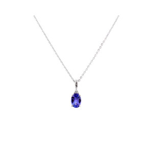 A 9ct white gold oval tanzanite and trefoil set diamond pendant and chain.