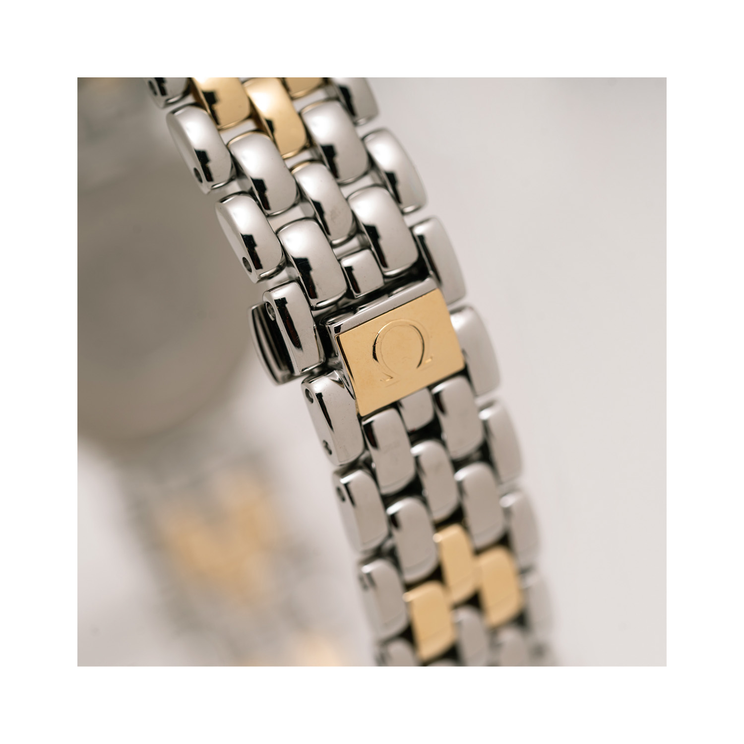 OMEGA, De Ville Two-Tone, Quartz Women's Watch OMEGA, De Ville with a 23mm two-tone stainless steel and yellow gold case and bracelet strap featuring a gold coloured dial.