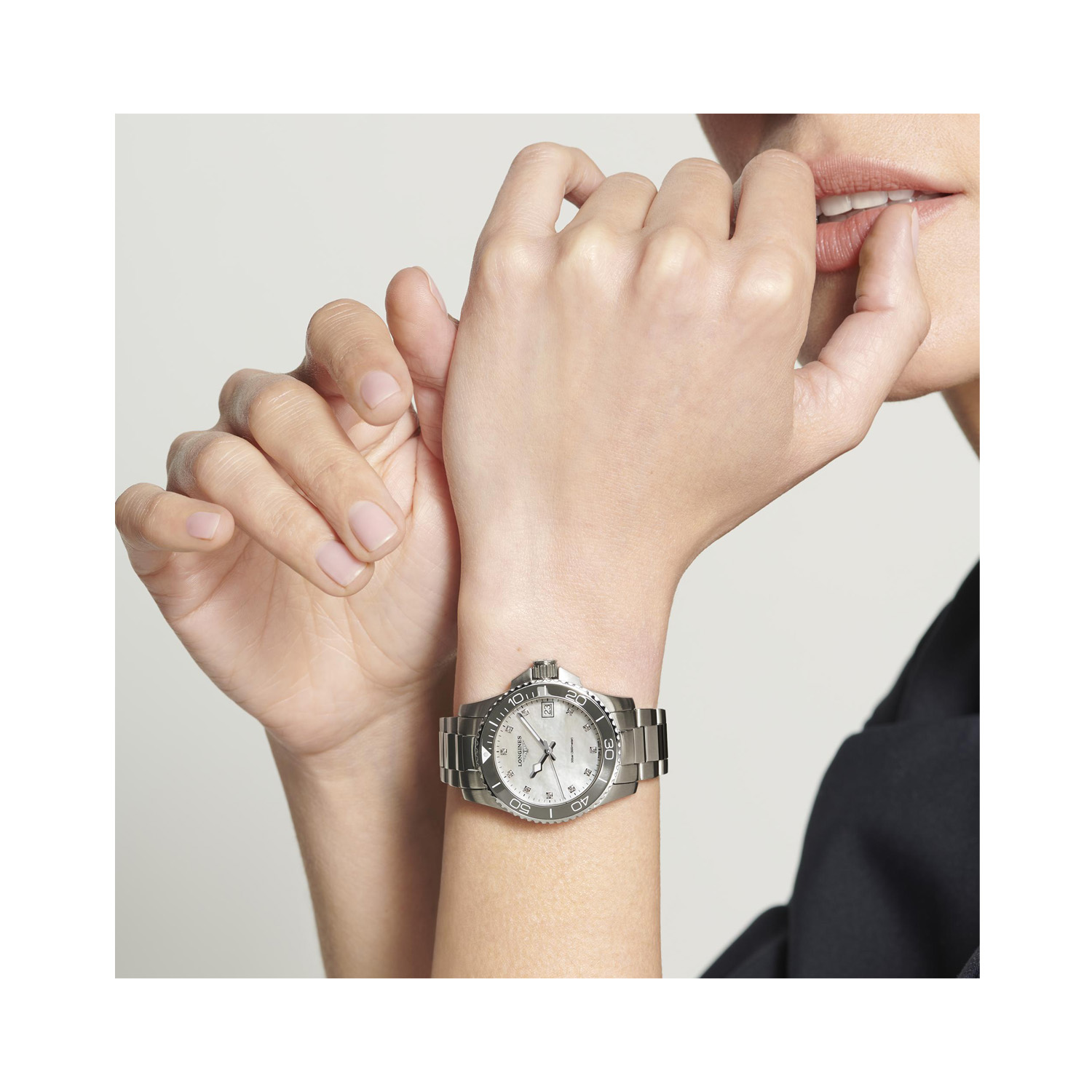 Longines, HydroConquest with a 32mm stainless steel case and bracelet strap featuring a date function and a white mother of pearl, diamond set dial with a grey ceramic bezel.