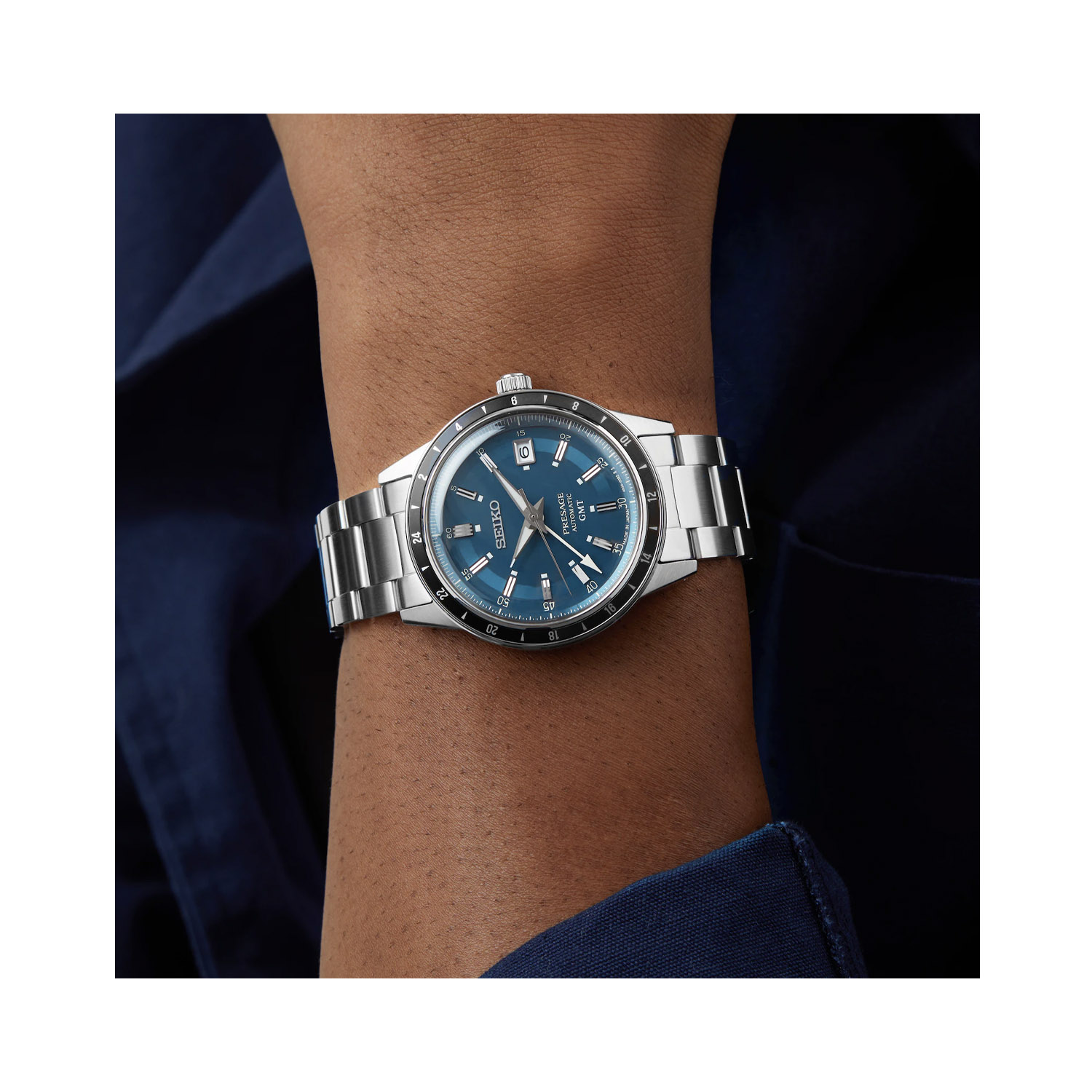 Seiko, Presage, 'Petrol Blue' Style 60s Road Trip, Automatic, GMT Men's Watch Seiko, Presage 'Petrol Blue' Style 60s Road Trip with a 40.7mm stainless steel case and bracelet strap featuring a date and GMT function, blue dial and a black bezel.