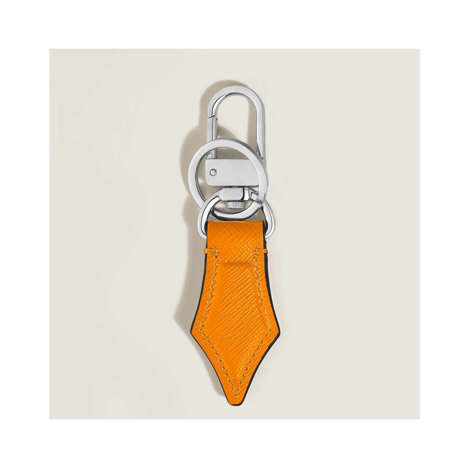 A Montblanc, Sartorial nib key holder in saffron coloured sartorial leather and shaped to resemble the shape of a pen nib for those who love the art of writing.