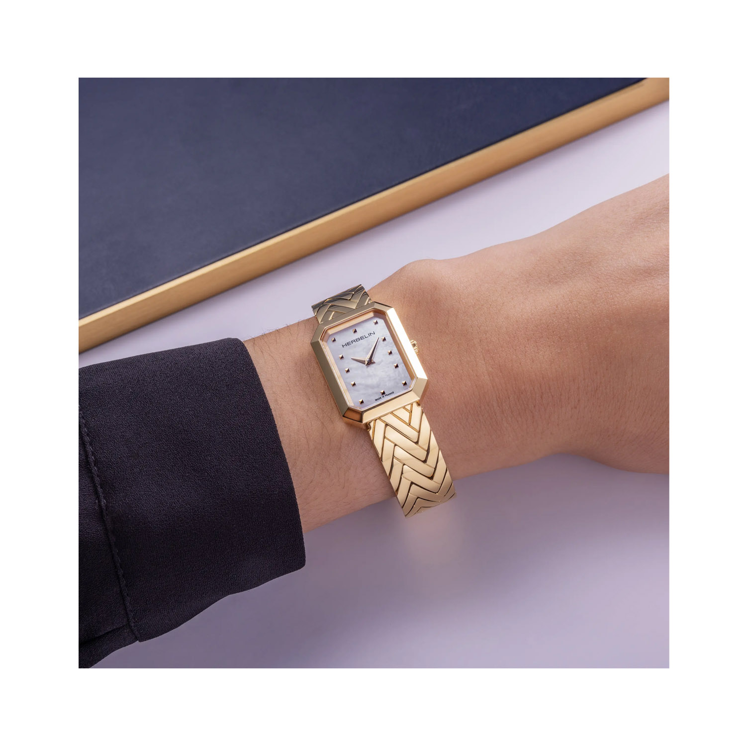 Herbelin, Octogône with a 26.4mm yellow gold PVD coated stainless steel rectangular case and bracelet strap featuring a white mother of pearl dial.