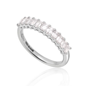 A platinum eleven stone emerald cut claw set diamond half eternity ring.