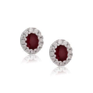 A pair of 18ct white gold oval shaped ruby and round brilliant cut diamond set cluster stud earrings, with a post and butterfly fastening for pierced ears.