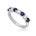 A platinum seven stone sapphire and diamond half eternity ring with a v-collet setting, belonging to H. L. Brown’s Volante collection.