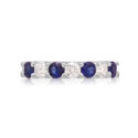 A platinum seven stone sapphire and diamond half eternity ring with a v-collet setting, belonging to H. L. Brown’s Volante collection.