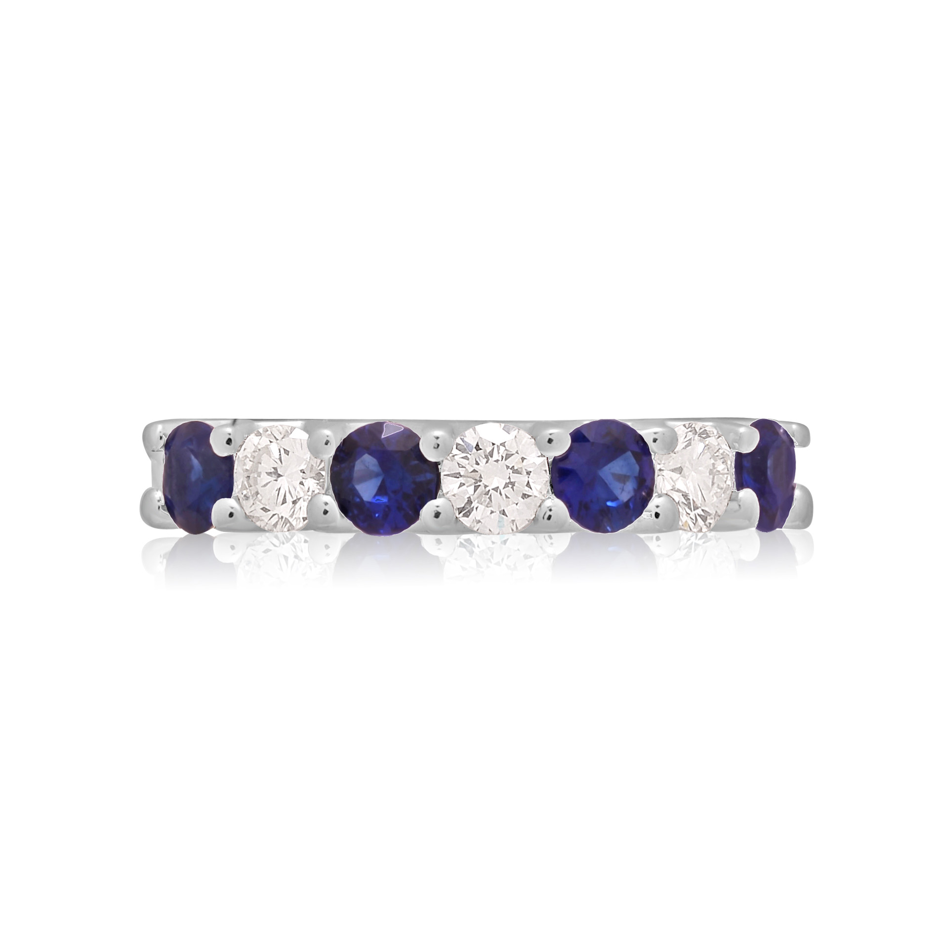 A platinum seven stone sapphire and diamond half eternity ring with a v-collet setting, belonging to H. L. Brown’s Volante collection.