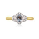 An 18ct yellow gold and platinum oval shaped aquamarine and round brilliant cut diamond set fancy cluster ring.