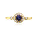 An 18ct yellow gold round sapphire and diamond millgrain set cluster ring with two diamonds set on each shoulder.