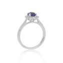 A platinum oval shaped sapphire and round brilliant cut diamond fancy cluster ring.