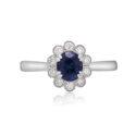 A platinum oval shaped sapphire and round brilliant cut diamond fancy cluster ring.
