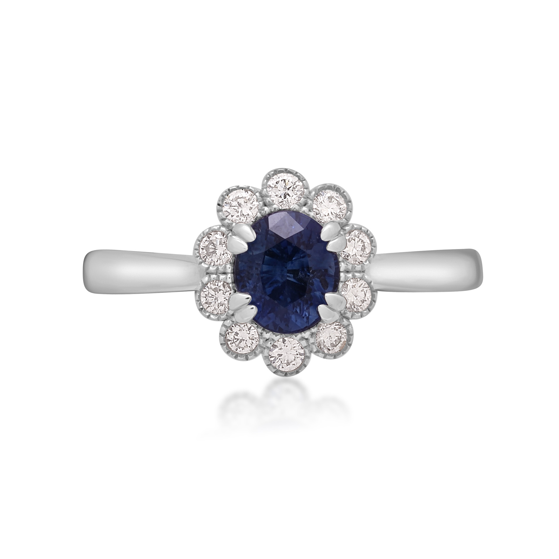 A platinum oval shaped sapphire and round brilliant cut diamond fancy cluster ring.
