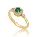 An 18ct yellow gold round emerald and diamond millgrain set cluster ring with two diamonds set on each shoulder.
