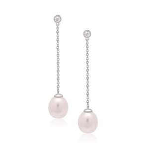A pair of 9ct white gold freshwater pearl earrings with a single rubover set diamond, with a post and butterfly fastening for pierced ears.