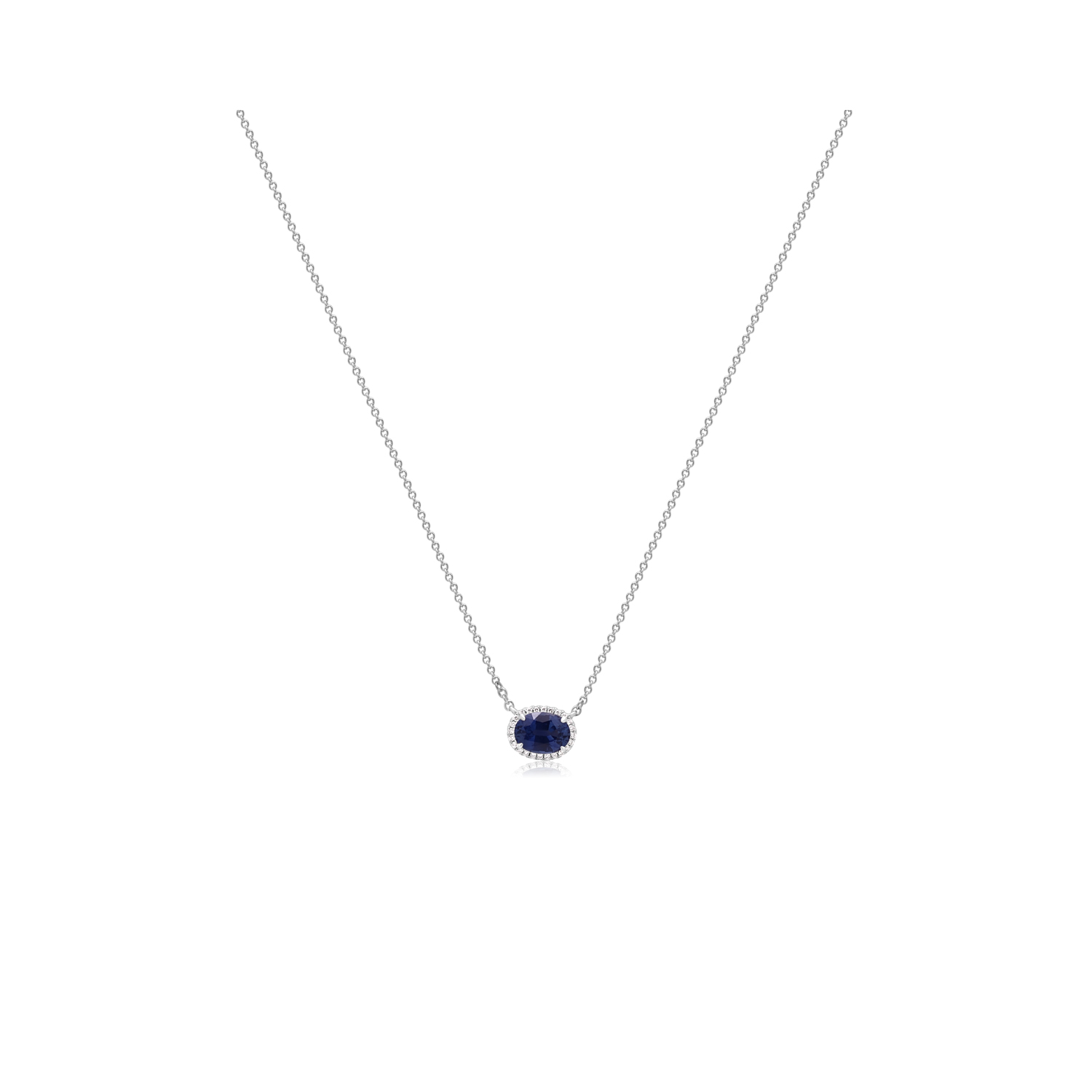 An 18ct white gold oval shaped sapphire and round brilliant cut diamond cluster pendant on an adjustable cable chain.