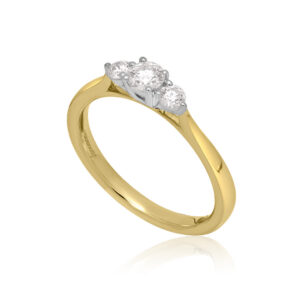 An 18ct yellow and white gold round brilliant cut diamond three stone ring.