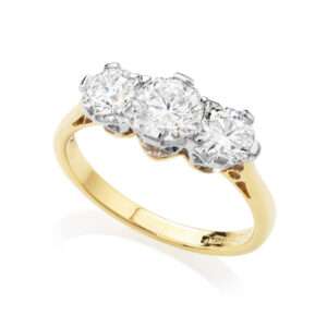 An 18ct yellow and white gold three stone ring with traditional style round brilliant cut diamonds.