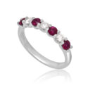 A platinum ruby and diamond seven stone half eternity ring with a v-collet setting, belonging to H. L. Brown's Volante collection.