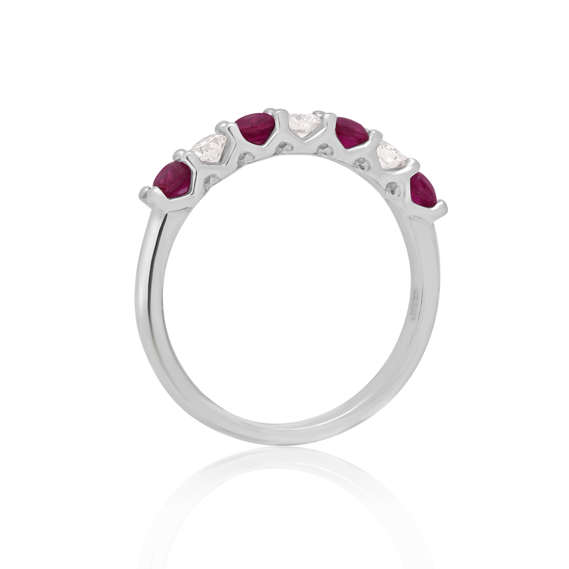 A platinum ruby and diamond seven stone half eternity ring with a v-collet setting, belonging to H. L. Brown's Volante collection.
