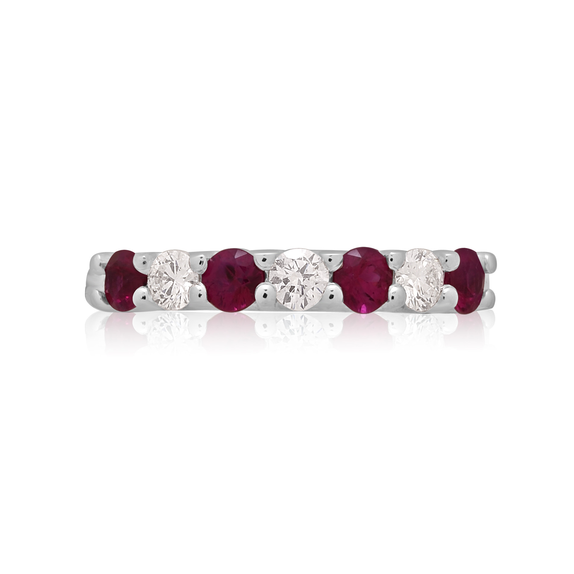 A platinum ruby and diamond seven stone half eternity ring with a v-collet setting, belonging to H. L. Brown's Volante collection.