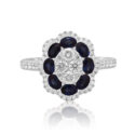 18ct White Gold Sapphire & Diamond Flower Cluster Ring An 18ct white gold oval shaped sapphire and diamond flower cluster ring, with diamond set shoulders.