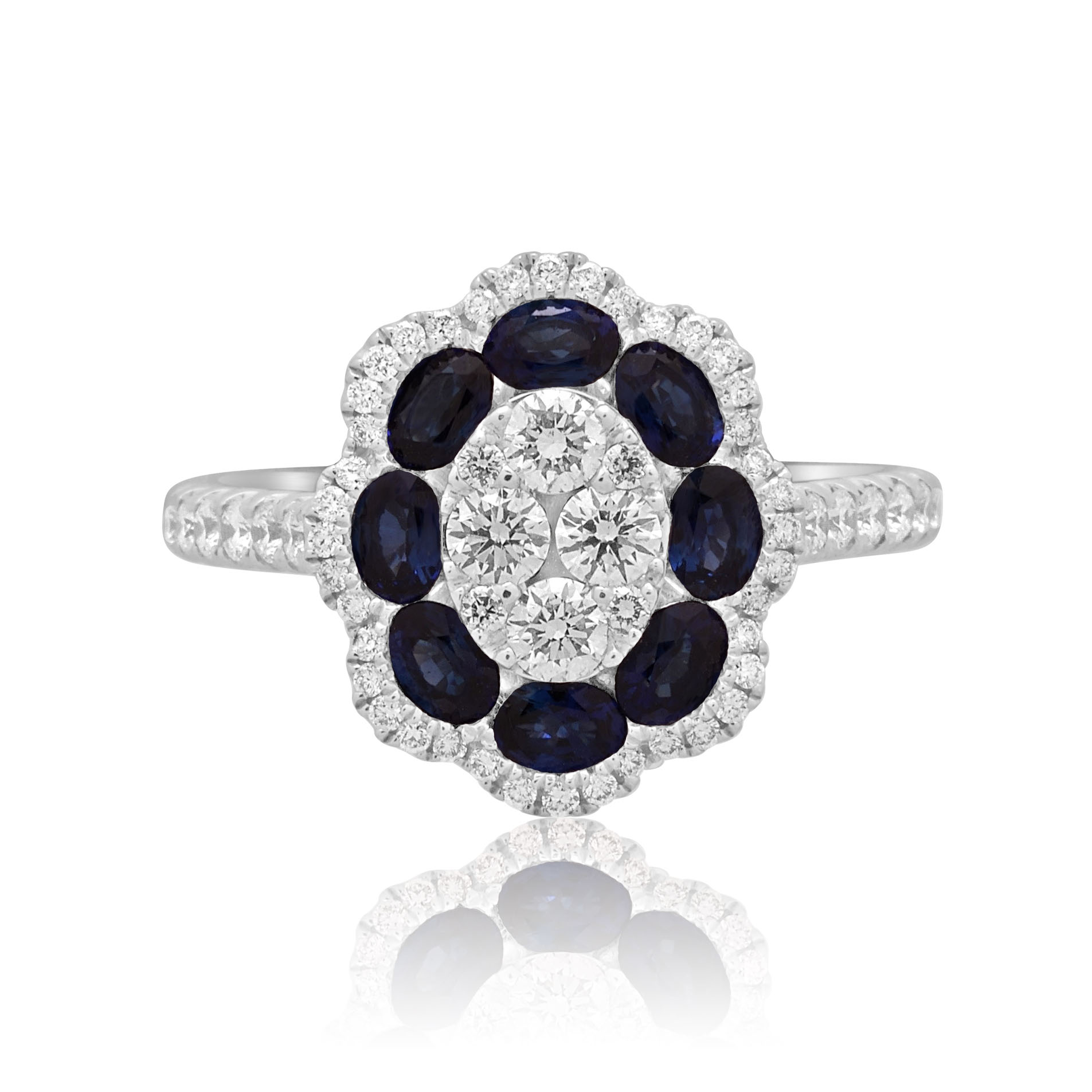 18ct White Gold Sapphire & Diamond Flower Cluster Ring An 18ct white gold oval shaped sapphire and diamond flower cluster ring, with diamond set shoulders.