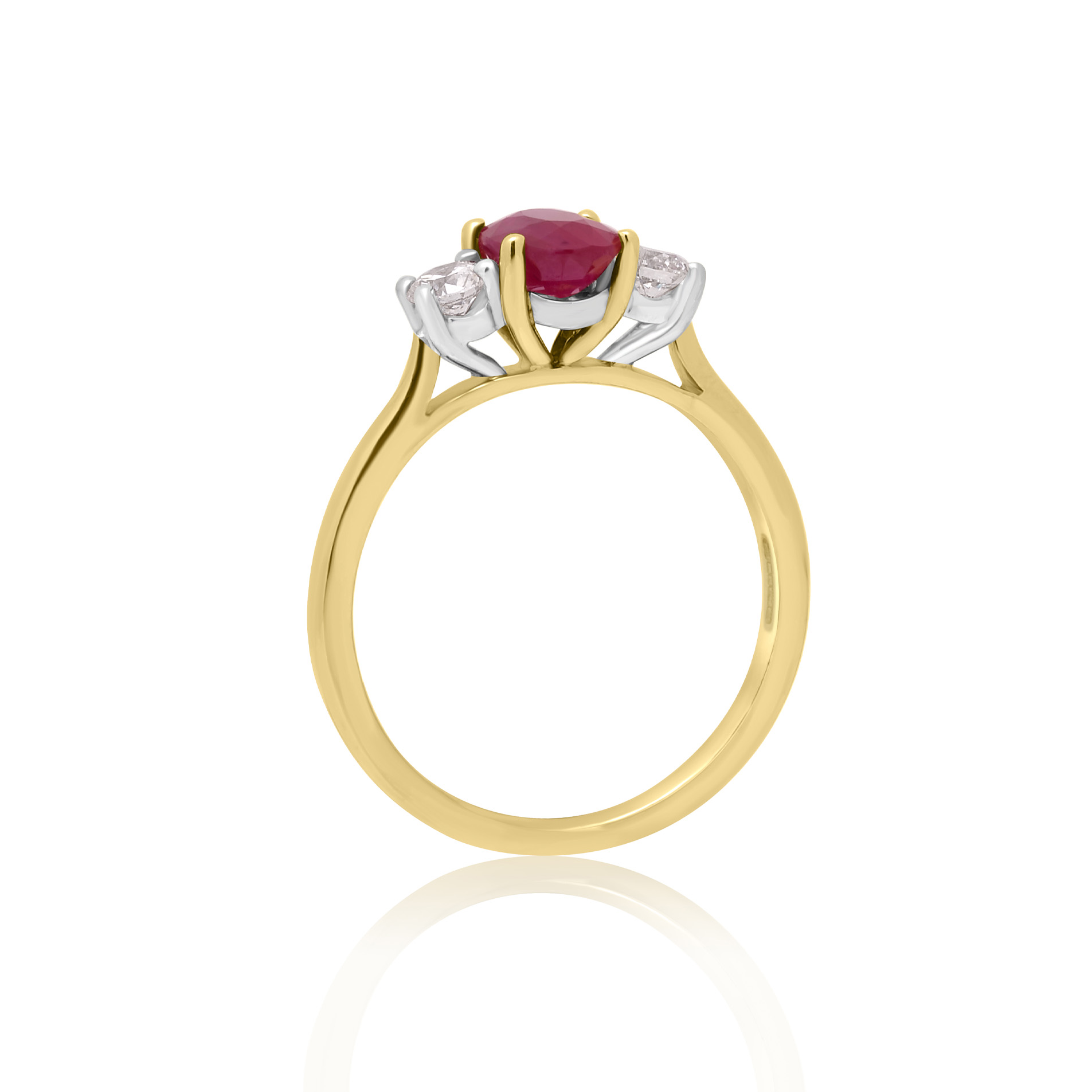An 18ct yellow gold oval ruby and round brilliant cut diamond three stone ring.