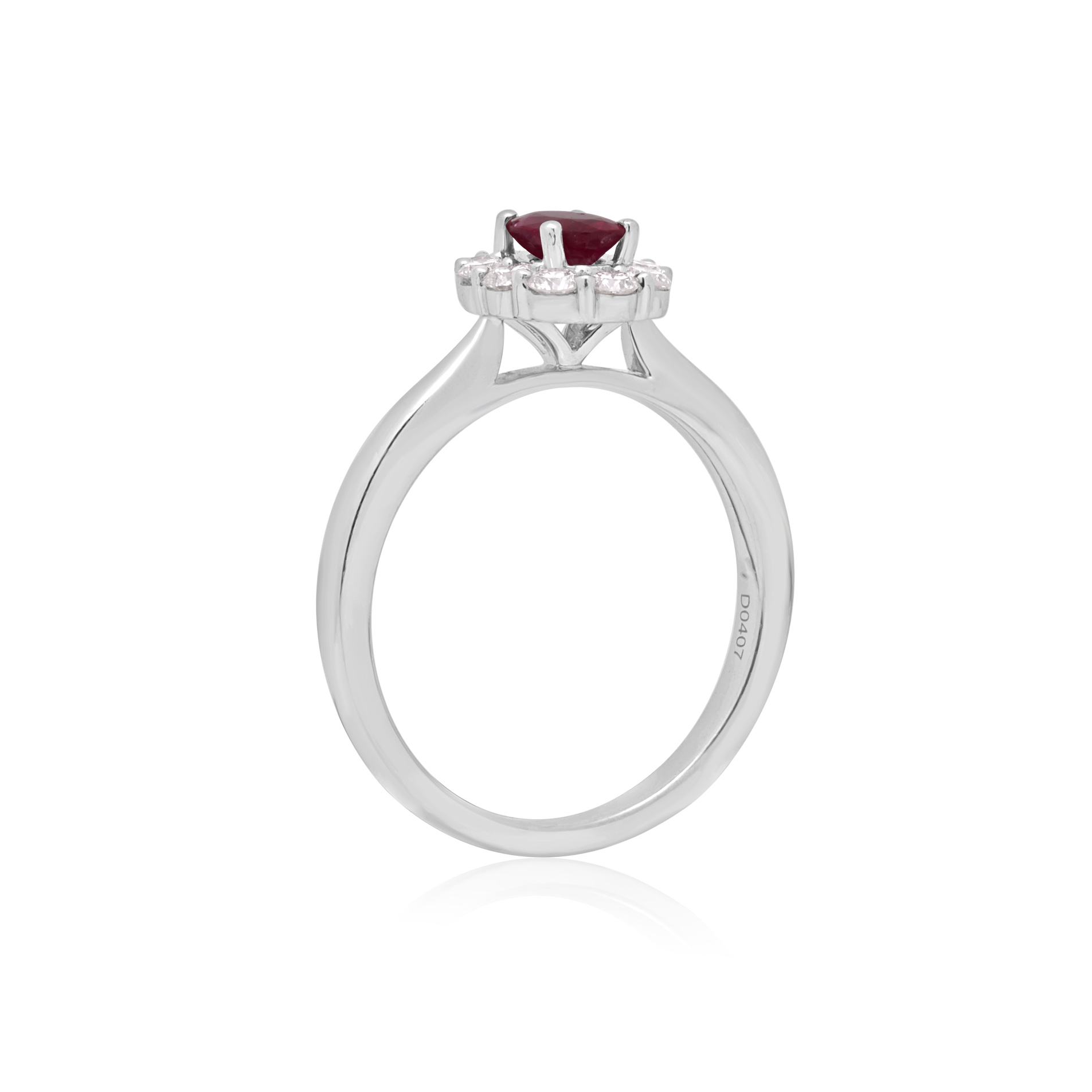 Platinum Oval Ruby & Brilliant Cut Diamond Cluster Ring A platinum, oval shaped ruby and brilliant cut diamond set cluster ring.