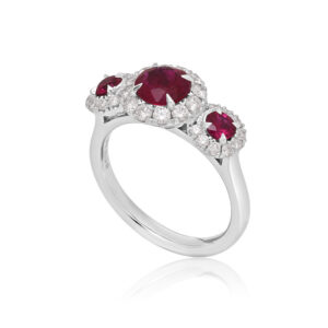 A platinum ruby and brilliant cut diamond set triple cluster ring.