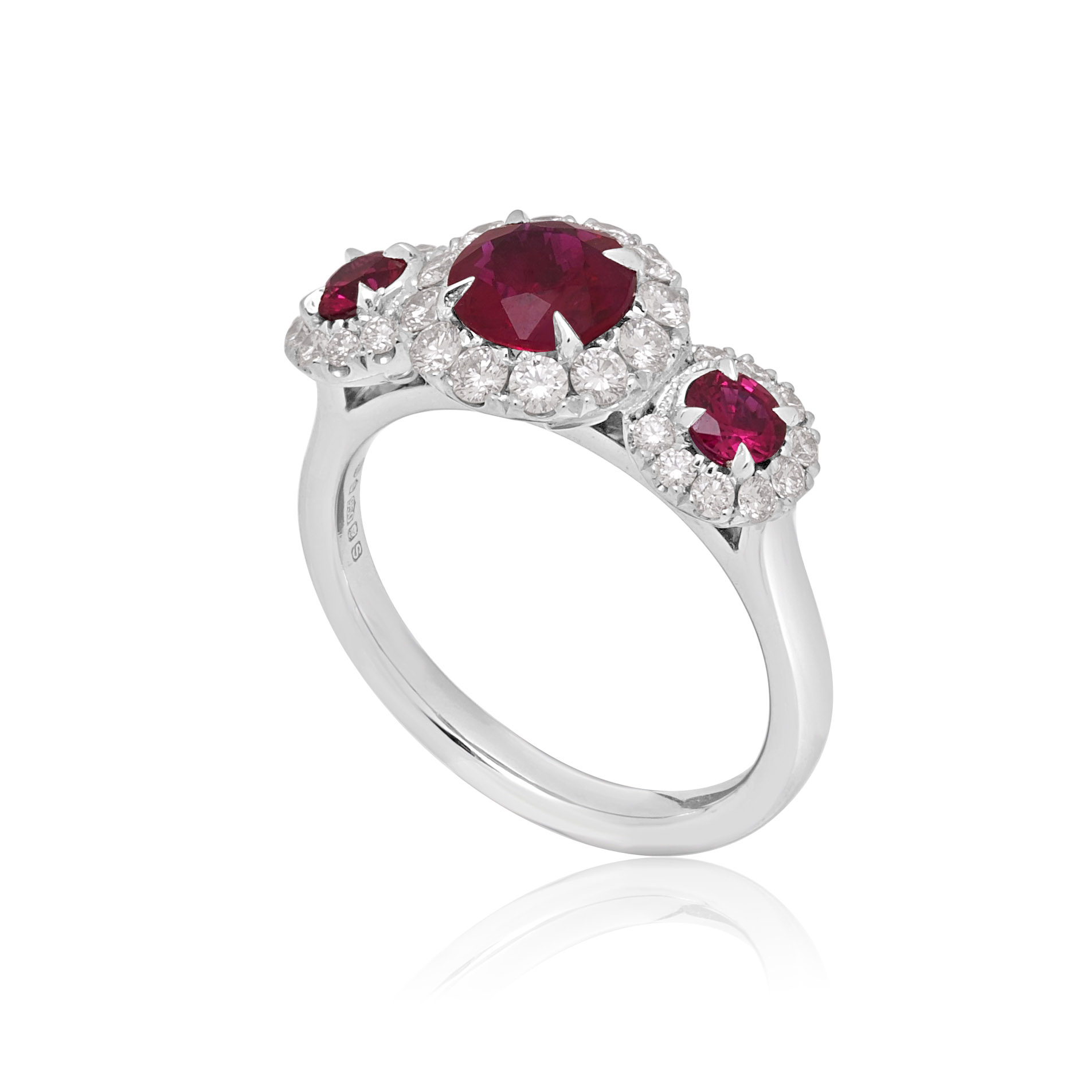 Platinum Ruby & Diamond Triple Cluster Ring A platinum ruby and brilliant cut diamond set triple cluster ring.