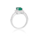 An 18ct white gold emerald and brilliant cut diamond cluster ring with diamond set shoulders.