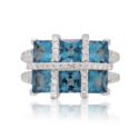 18ct White Gold Topaz & Diamond Ring An 18ct white gold blue topaz six stone fancy cluster ring with diamonds set to the shoulders.
