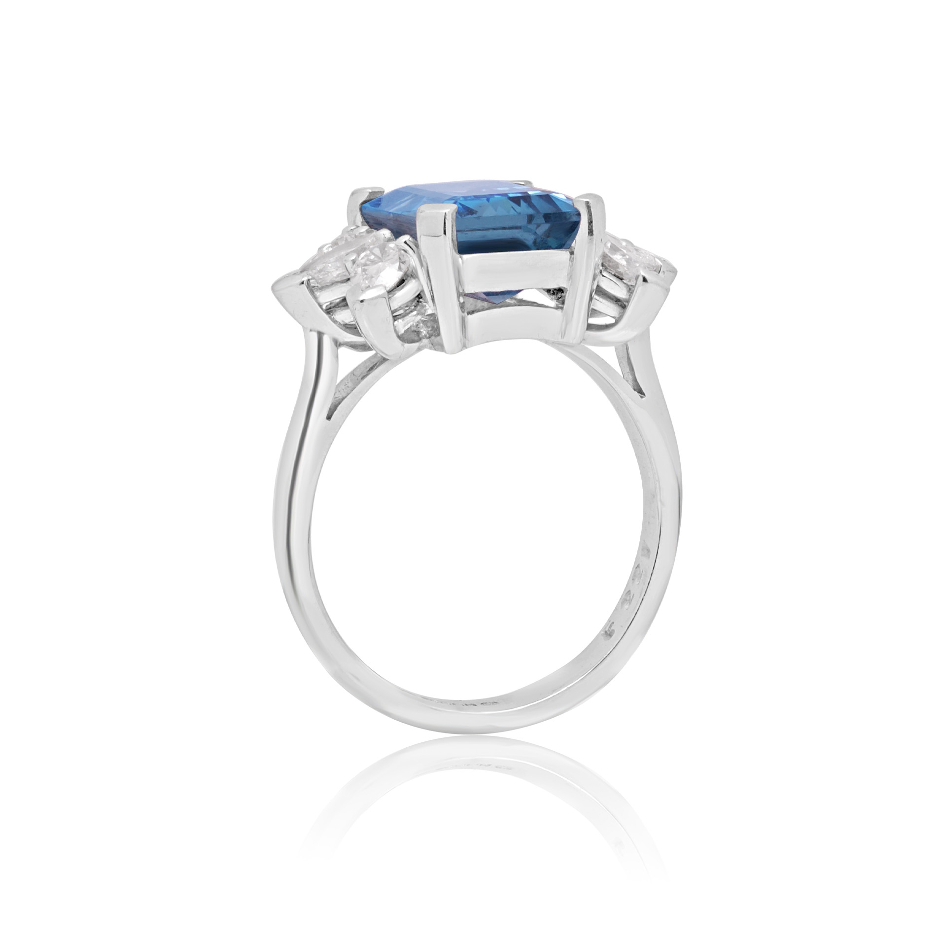 18ct White Gold Emerald Cut Aquamarine & Diamond Dress Ring An 18ct white gold emerald cut aquamarine ring with pear shaped diamond set shoulders.