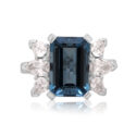 18ct White Gold Emerald Cut Aquamarine & Diamond Dress Ring An 18ct white gold emerald cut aquamarine ring with pear shaped diamond set shoulders.