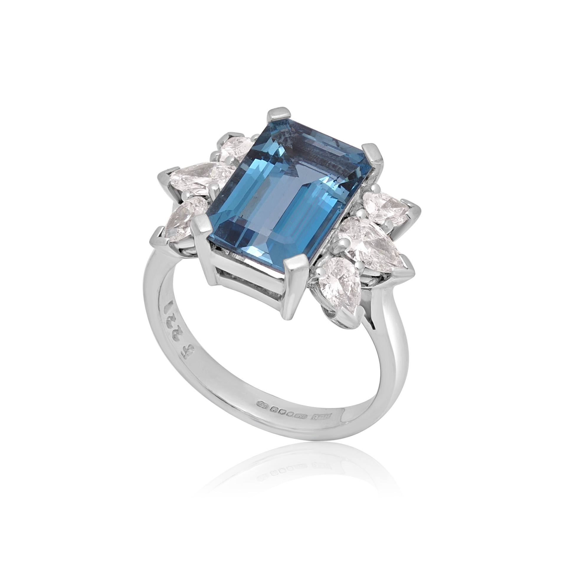 18ct White Gold Emerald Cut Aquamarine & Diamond Dress Ring An 18ct white gold emerald cut aquamarine ring with pear shaped diamond set shoulders.